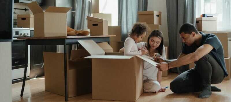 family packing boxes in kitchen