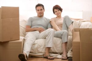 couple sitting among boxes